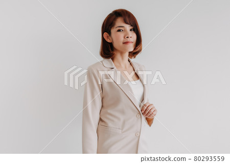 Confident Asian working woman in beige blazer isolated on white. 80293559