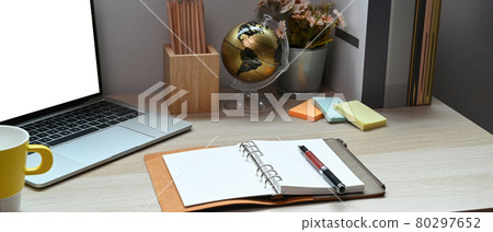 Notebook, laptop computer and supplies on wooden desk. 80297652