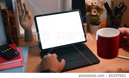 Close up view female drinking coffee and using computer tablet. Close up view female drinking coffee and using computer tablet. 80297682