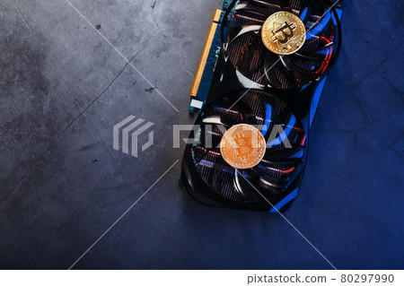 Bitcoin coin on a powerful graphics card for mining and earning cryptocurrency concept Bitcoin coin on a powerful graphics card for mining and earning cryptocurrency concept 80297990