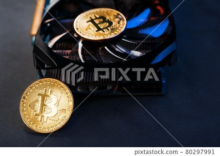 Gold bitcoins on a video card with a blue backlight in the style of cyberpunk. Gold bitcoins on a video card with a blue backlight in the style of cyberpunk. 80297991