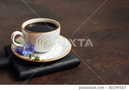 Cup with chicory drink on a wooden tray on a brown background. Alternative to coffee. Healthy beverage. Space for text. Cup with chicory drink on a wooden tray on a brown background. Alternative to coffee. Healthy beverage. Space for text. 80299587