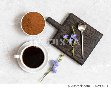 Chicory beverage, chicory powder and blue flowers on a white background. Useful herbal drink without caffeine. Top view, flat lay. 80299601