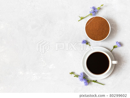 Chicory coffee drink, powder and blue flowers on a white background. Healthy beverage, coffee substitute. Copy space, top view 80299602