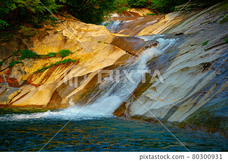 Kagawa Valley where the flow of water continues beautifully on the smooth rock surface made of granodiorite monolith Kagawa Valley where the flow of water continues beautifully on the smooth rock surface made of granodiorite monolith 80300931
