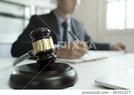 Male lawyer in the office with brass scale. 80301877