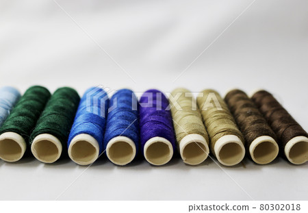 10 colorful hand-sewn threads lined up on the cloth 10 colorful hand-sewn threads lined up on the cloth 80302018