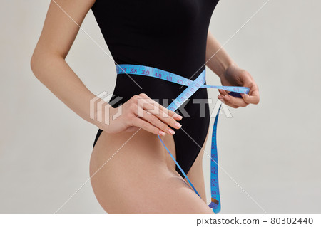 blonde woman with perfect body with measuring tape blonde woman with perfect body with measuring tape 80302440