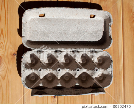 Grey egg carton without eggs on white background. Grey egg carton without eggs on white background. 80302470