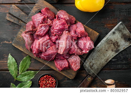Beef casserole or goulash ingredients with sweet bell pepper, on old dark wooden table , top view flat lay Beef casserole or goulash ingredients with sweet bell pepper, on old dark wooden table , top view flat lay 80302957