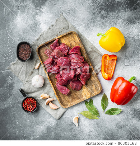 Irish raw Beef Stew Recipe ingredients with sweet bell pepper, on gray stone background, top view flat lay, square format 80303168