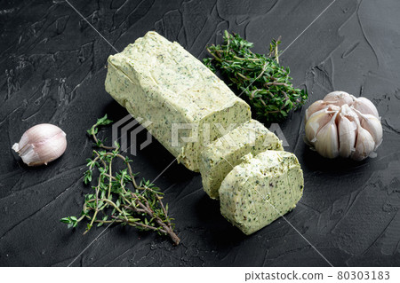 Fresh green herb butter, on black stone background 80303183
