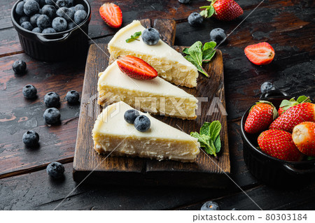 Slice Of Classical New York Cheesecake, on old dark wooden table background 80303184