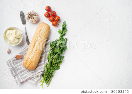 Toasted bread Baguette with garlic and herbs ingredients, on white stone table background, top view flat lay, with copy space for text Toasted bread Baguette with garlic and herbs ingredients, on white stone table background, top view flat lay, with copy space for text 80303345