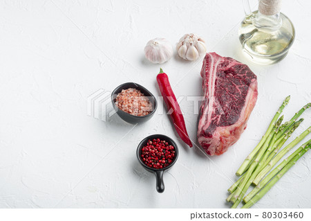Fresh and raw beef meat, whole piece, on white stone surface, Club steak cut, with copy space for text Fresh and raw beef meat, whole piece, on white stone surface, Club steak cut, with copy space for text 80303460