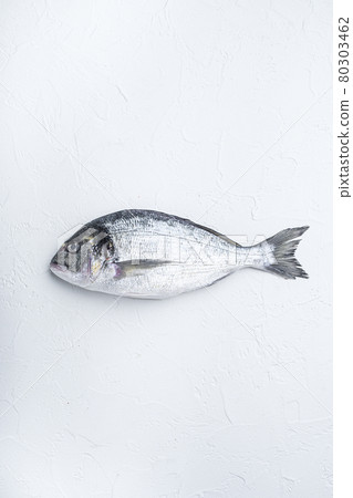 Raw sea bream or Gilt head bream dorada fish on white background, top view. 80303462