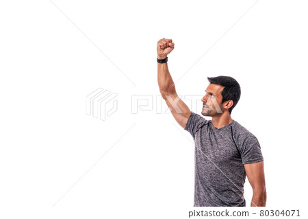 A middle-aged man of athletic build with a raised hand up. Fight. Copy space. Isolated on a white background. 80304071