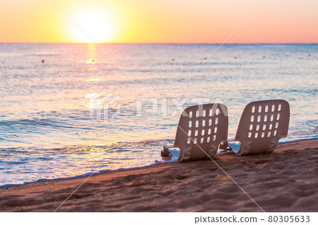 Landscape of Two Lonely beachchairs near sea and beautiful sunrise Landscape of Two Lonely beachchairs near sea and beautiful sunrise 80305633
