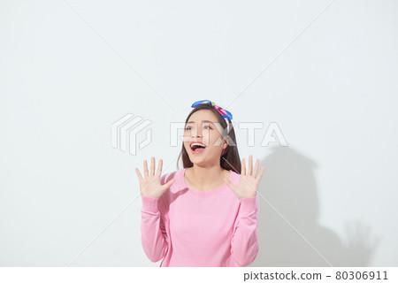 Image of surprised young woman showing her hands isolated over white background Image of surprised young woman showing her hands isolated over white background 80306911
