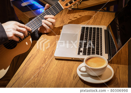 music vlogger streaming a live video while playing acoustic guitar and having a good time with coffee music vlogger streaming a live video while playing acoustic guitar and having a good time with coffee 80306998