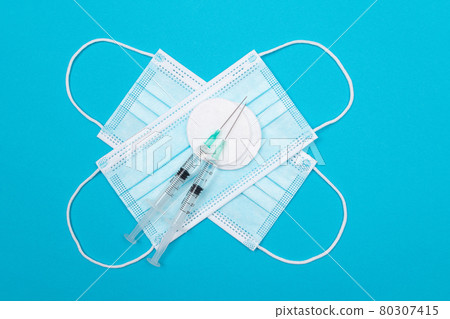 Vaccination or Revaccination Concept - Two Medical Syringe on Blue Table 80307415
