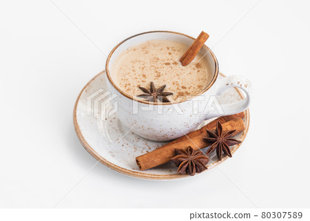 Indian Masala chai tea. Traditional Indian hot drink with milk and spices on white background closeup. 80307589