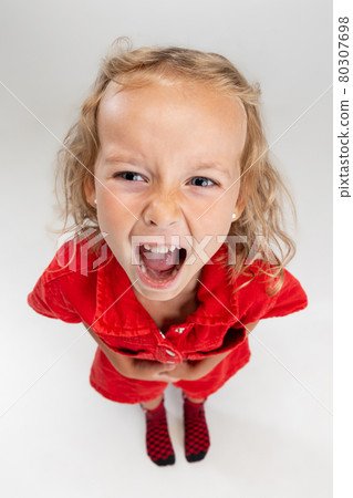 One preschool Caucasian cute girl in red romper posing isolated over white studio background. View from above One preschool Caucasian cute girl in red romper posing isolated over white studio background. View from above 80307698