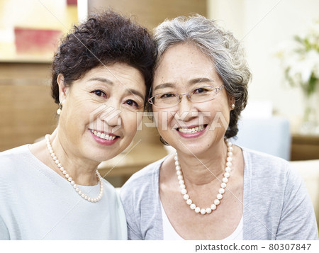 portrait of two senior asian women looking at camera smiling 80307847