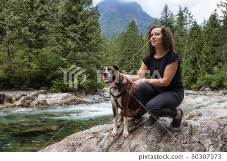 Woman hiking with Boxer Dog in the Canadian Nature Woman hiking with Boxer Dog in the Canadian Nature 80307973