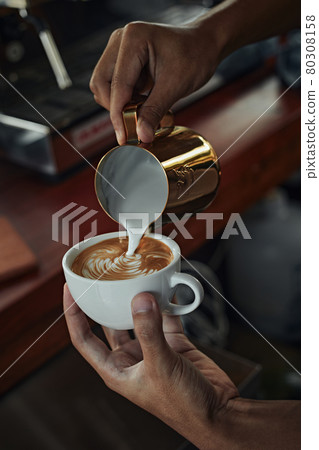 coffee latte art making by barista . 80308158
