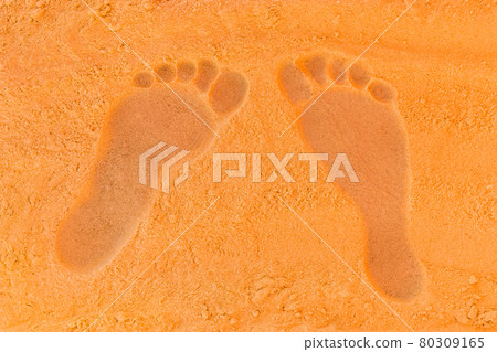 Trail from the man's foot on the orange beach sand background close-up Trail from the man's foot on the orange beach sand background close-up 80309165
