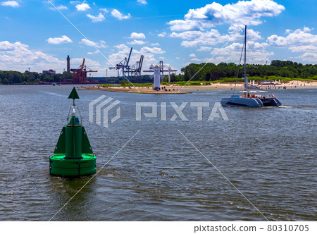 Swinoujscie. The famous old windmill lighthouse on a sunny day. Swinoujscie. The famous old windmill lighthouse on a sunny day. 80310705
