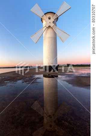 Swinoujscie. Famous old windmill lighthouse at sunrise. Swinoujscie. Famous old windmill lighthouse at sunrise. 80310707