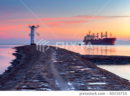 Swinoujscie. Famous old windmill lighthouse at sunrise. Swinoujscie. Famous old windmill lighthouse at sunrise. 80310710