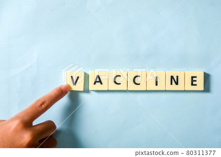 Children hand completing vaccine word on the puzzle 80311377
