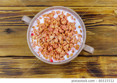 Granola with milk in bowl on wooden table. Top view. Healthy breakfast concept 80315512
