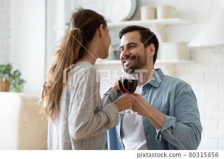 Couple in love holding wineglasses enjoy dating in modern kitchen Couple in love holding wineglasses enjoy dating in modern kitchen 80315856