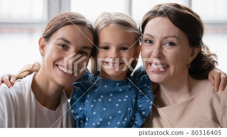 Portrait of happy three generations of women hugging 80316405