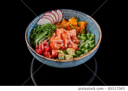 Poke bowl of salmon, mango, tomatoes, avocados, edamame beans, wakame seaweed, radish 80317065