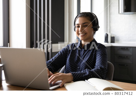 Happy Indian student taking part in virtual learning webinar 80317412