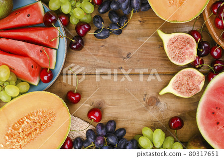 Different fruits on a wooden background. The concept of harvest and Italian winemaking. 15 Agusta Different fruits on a wooden background. The concept of harvest and Italian winemaking. 15 Agusta 80317651