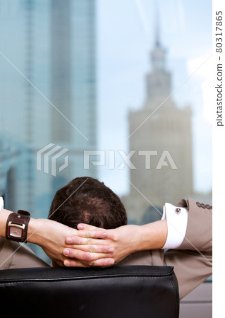 Businessman relaxing in office, rear view Businessman relaxing in office, rear view 80317865