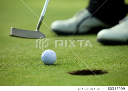 Person playing golf, low section 80317909