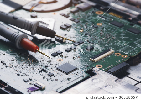 Multimeter probe placed on the motherboard of computer laptop Multimeter probe placed on the motherboard of computer laptop 80318657