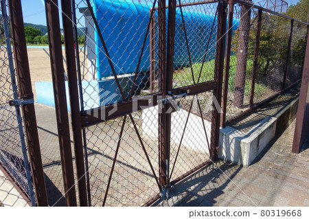 Locked double door of baseball field 80319668