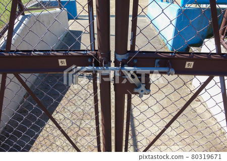 Locked double door of baseball field 80319671
