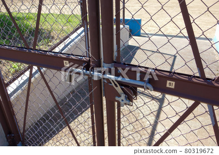 Locked double door of baseball field 80319672