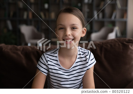 Happy gen Z kid talking at camera during video call Happy gen Z kid talking at camera during video call 80320122