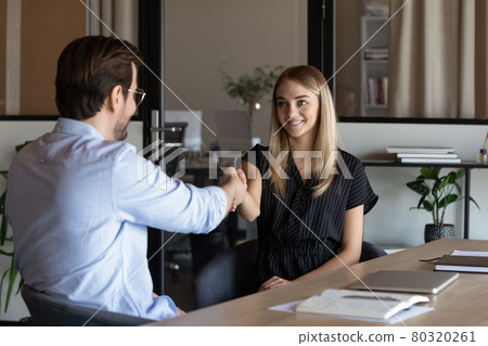Friendly hr manager greeting young woman candidate at job interview Friendly hr manager greeting young woman candidate at job interview 80320261