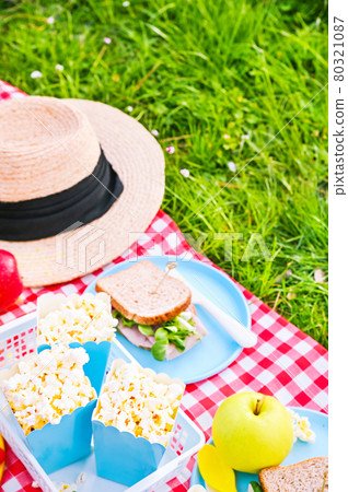 Lunch in the park on the green grass. Summer sunny day and picnic basket Lunch in the park on the green grass. Summer sunny day and picnic basket 80321087